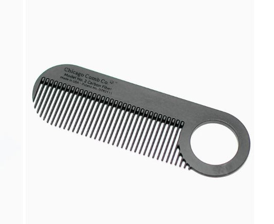 A sleek, black metal comb with fine and medium-width teeth, featuring a large circular handle, laid against a white background.