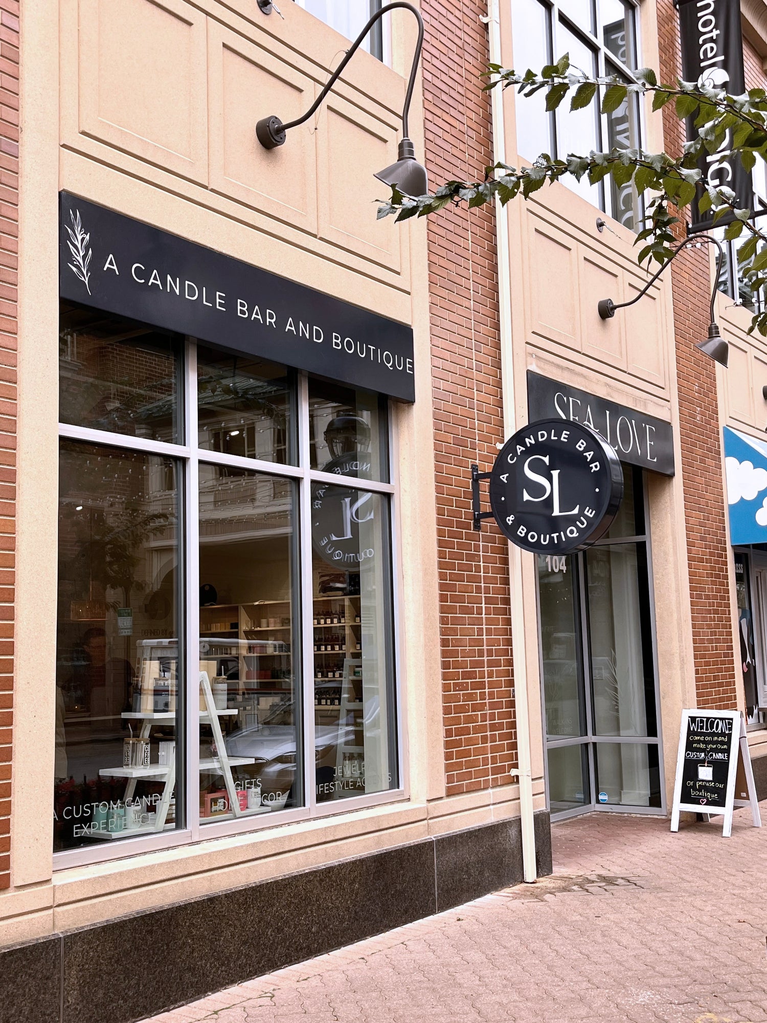 A quaint candle bar and boutique storefront on a city street, promising a unique experience for custom candle making and artisanal shopping.